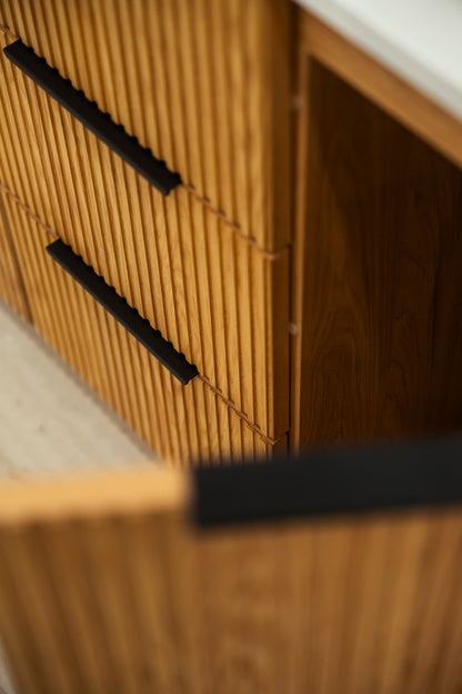 MALIBU natural oak fluted front and black handle detail